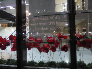 Remembrance poppies in the front window of Coutts