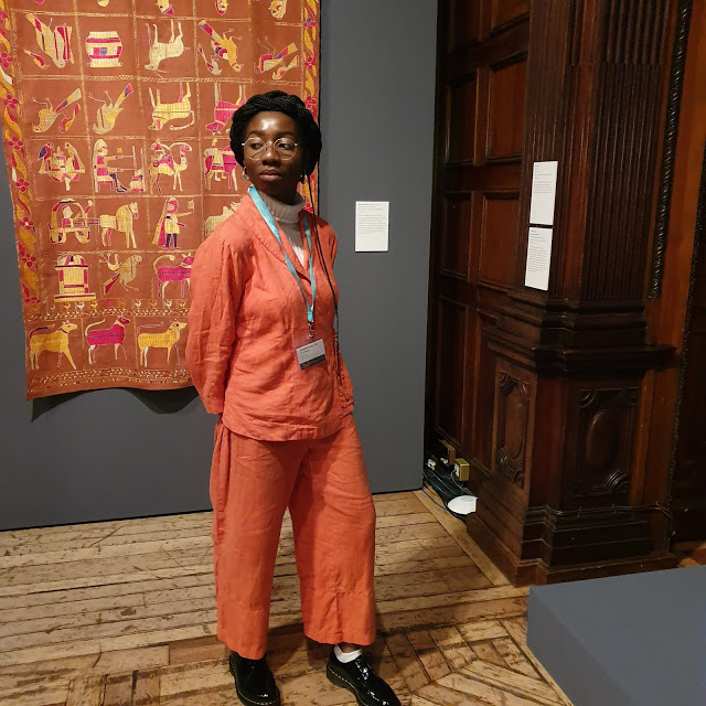 Kimberley at Two Temple Place infront of Phulkari, Punjab (Early 20th Century), Cotton with floss silk embroidery. Cartwright Hall Art Gallery, Bradford Museums and Galleries.