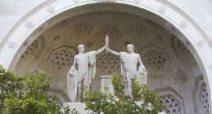 Closer shot of Britain and America statues raising torch.